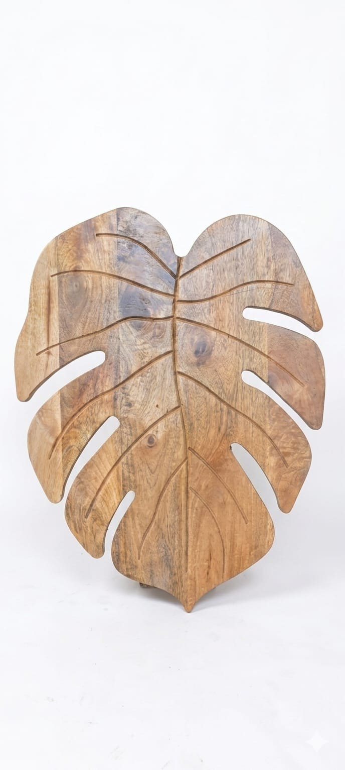 coffee table features a monstera leaf-shaped Sheesham wood top supported by matt
