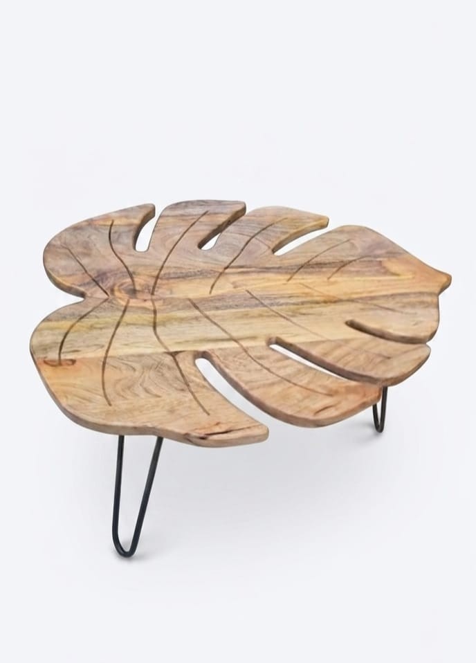 coffee table features a monstera leaf-shaped Sheesham wood top supported by matt