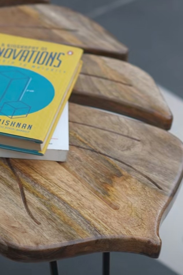 coffee table features a monstera leaf-shaped Sheesham wood top supported by matt